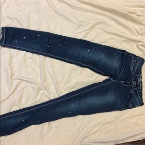 blue denim jeans with white paint splatters